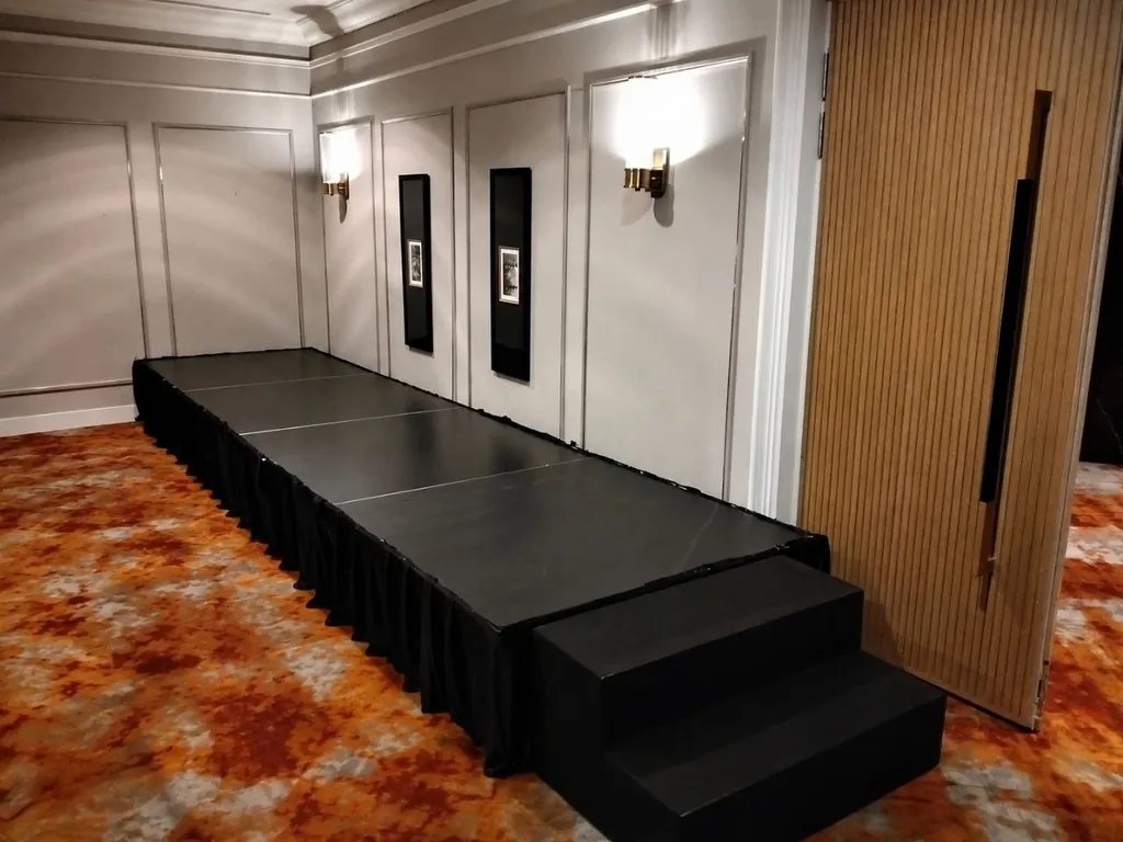 Low black platform stage with steps and skirting in a hotel function room in Singapore
