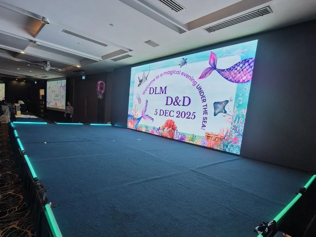 Carpeted platform stage with LED edge lighting for a dinner and dance event in Singapore