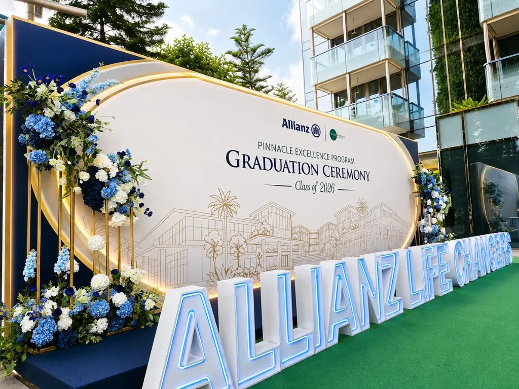 Graduation ceremony backdrop with blue floral display and illuminated LED letters in Singapore