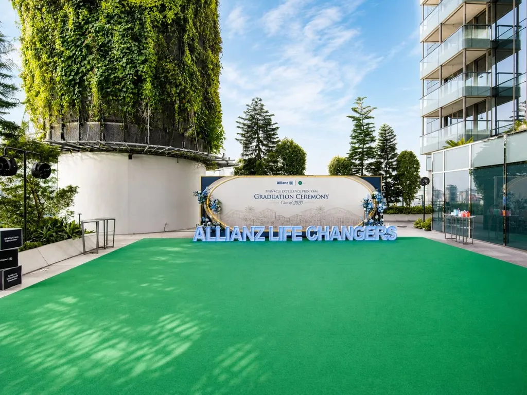 Outdoor graduation backdrop with green carpet flooring at a rooftop venue in Singapore